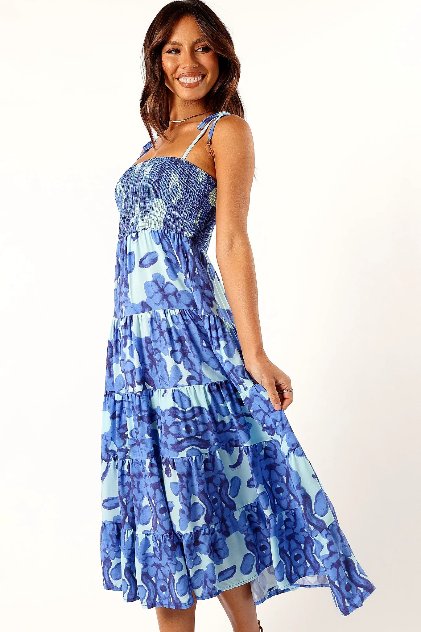 Drop tiered a-line skirt on a blue floral midi dress