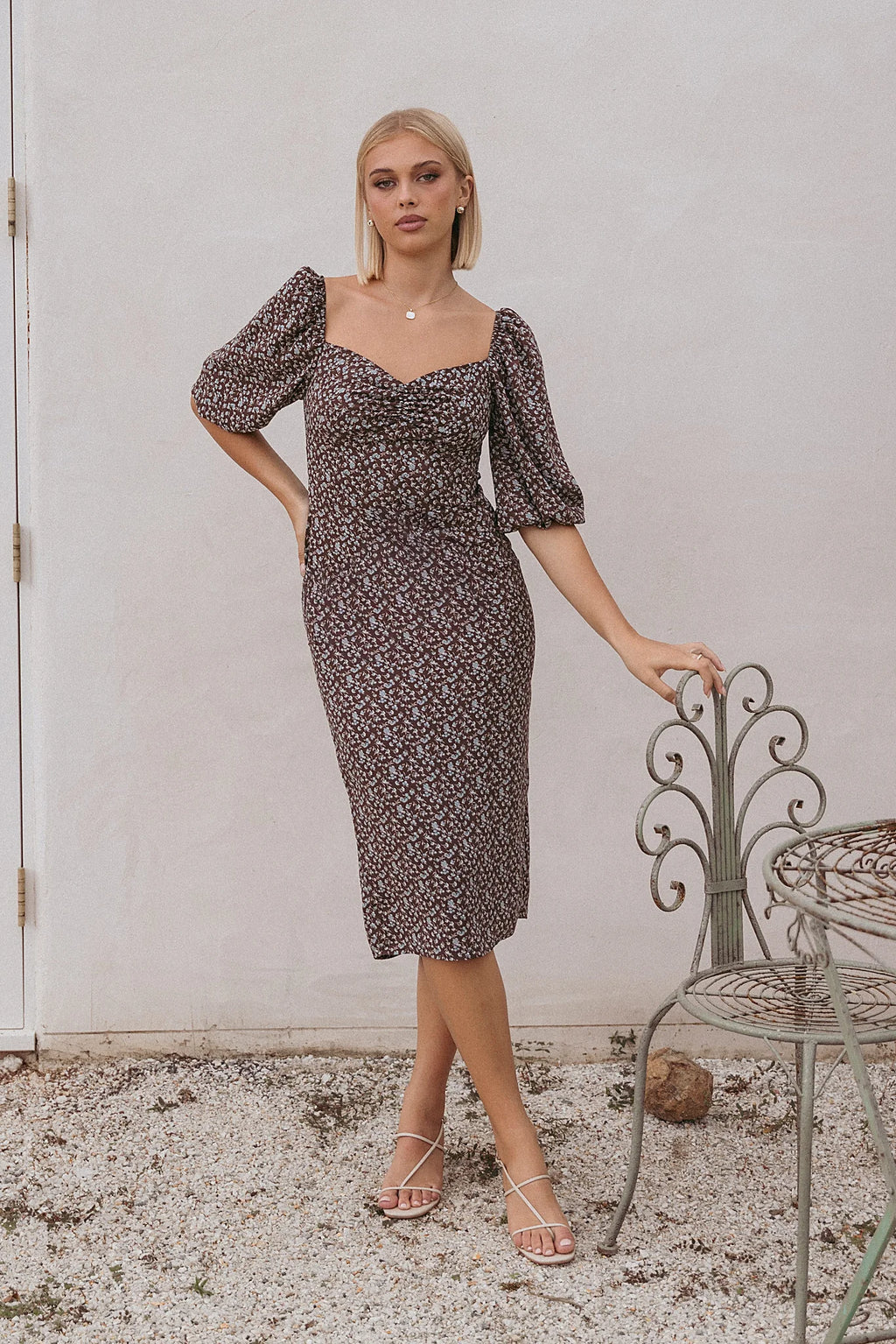 Ruched bust and mid length cuffed sleeves on a floral midi dress