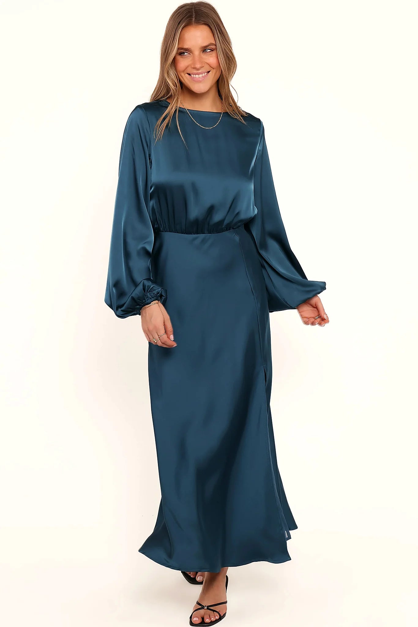 Front split and long cuffed sleeves on a teal satin midi dress