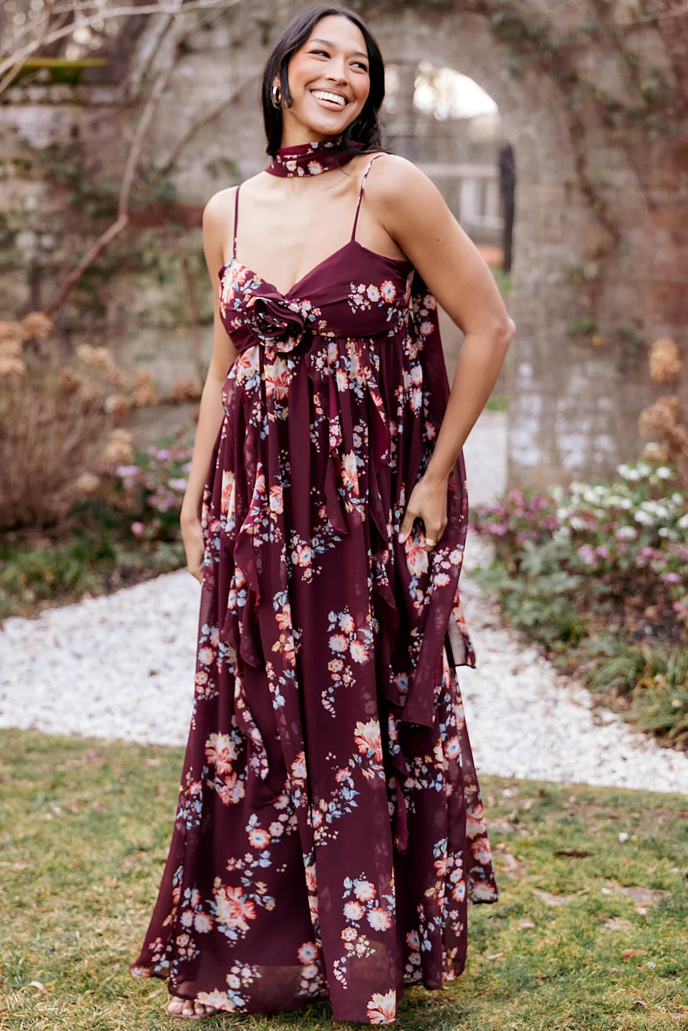 Decorative rosette and drape ruffle on a berry floral maxi dress